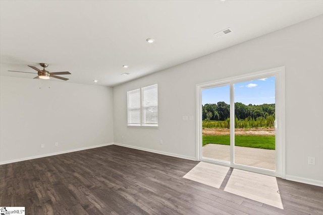 empty room with dark wood-type flooring and ceiling fan