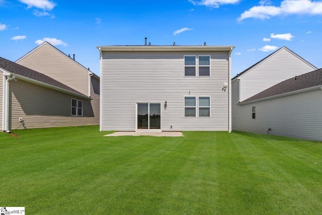 back of house with a patio and a yard