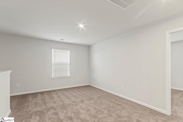 spare room with light carpet