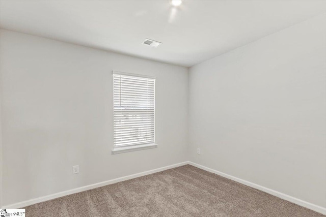 unfurnished room with light carpet