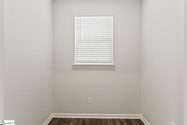 empty room with dark hardwood / wood-style floors