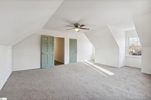 bonus room with ceiling fan, vaulted ceiling, and carpet flooring