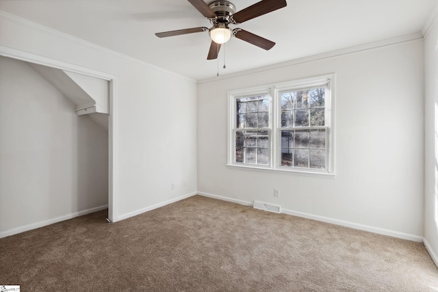 unfurnished bedroom featuring ceiling fan, carpet flooring, and crown molding