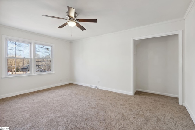 unfurnished bedroom with ceiling fan, ornamental molding, and carpet flooring