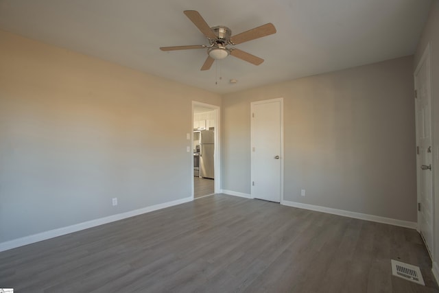 empty room featuring ceiling fan and hardwood / wood-style flooring