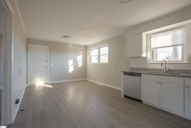 kitchen with dishwasher, wood-type flooring, sink, white cabinetry, and light stone countertops