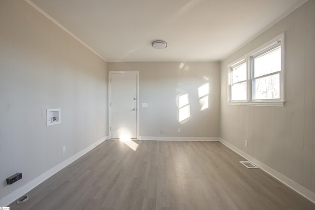 unfurnished room with crown molding and hardwood / wood-style flooring