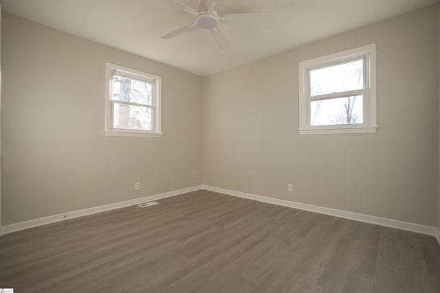 unfurnished room featuring ceiling fan and dark wood-type flooring