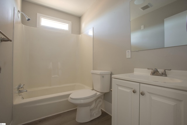 full bathroom with shower / bathing tub combination, wood-type flooring, toilet, and vanity