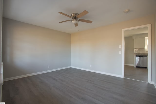 unfurnished room with ceiling fan and dark hardwood / wood-style floors