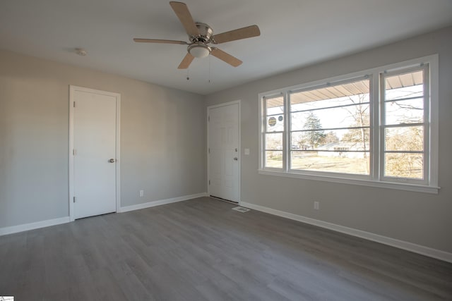 unfurnished room with ceiling fan and dark hardwood / wood-style floors