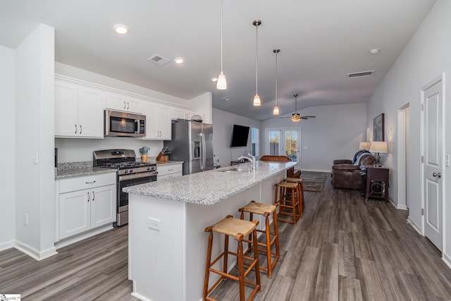 kitchen with ceiling fan, white cabinetry, appliances with stainless steel finishes, and a kitchen island with sink