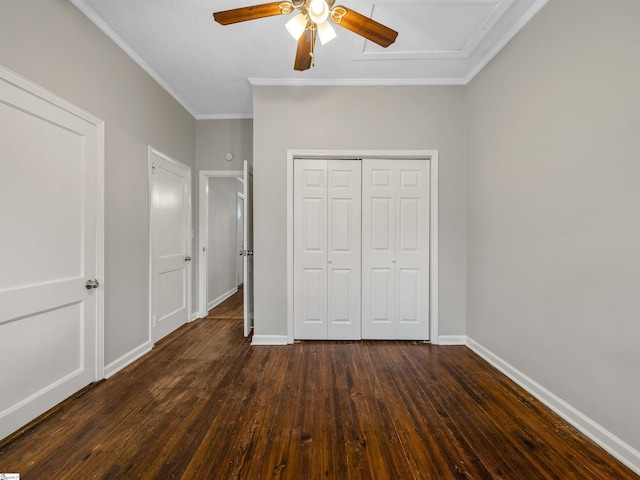 unfurnished bedroom with a closet, crown molding, dark hardwood / wood-style floors, and ceiling fan