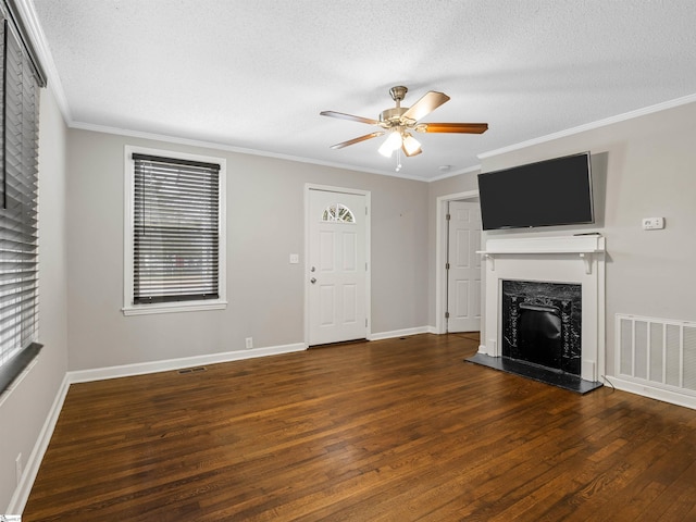 unfurnished living room featuring ceiling fan, a high end fireplace, ornamental molding, a textured ceiling, and dark hardwood / wood-style flooring