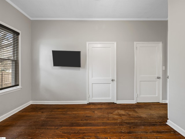 unfurnished room featuring ornamental molding and dark hardwood / wood-style floors