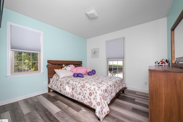 bedroom with dark hardwood / wood-style flooring