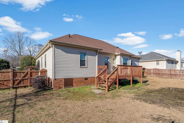 back of house with a lawn and a wooden deck