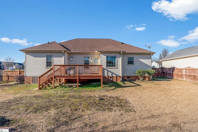 rear view of house featuring a deck and a lawn