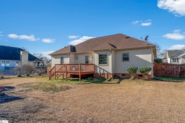 rear view of property featuring a deck and a yard