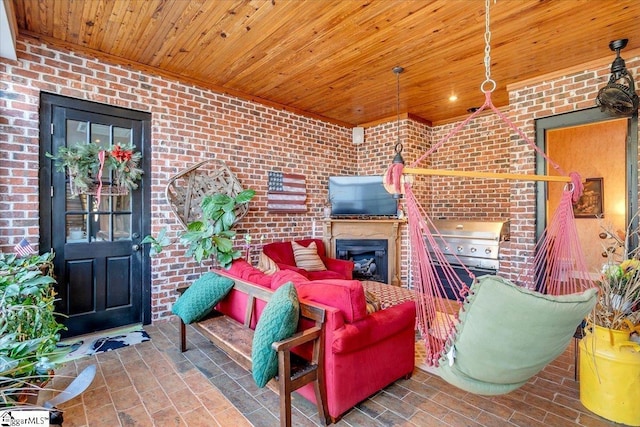 view of patio with exterior kitchen and a grill