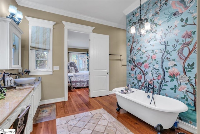 bathroom with vanity, a bathtub, crown molding, and hardwood / wood-style floors