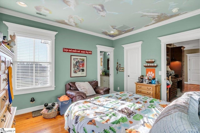 bedroom featuring crown molding and hardwood / wood-style floors