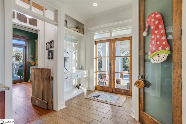 doorway featuring hardwood / wood-style flooring, plenty of natural light, crown molding, and french doors