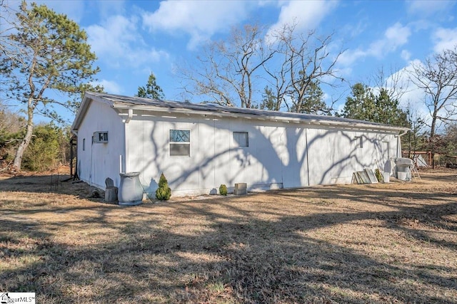 rear view of house featuring a yard