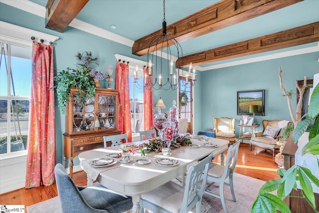 dining room featuring light wood-type flooring, crown molding, a notable chandelier, and beamed ceiling