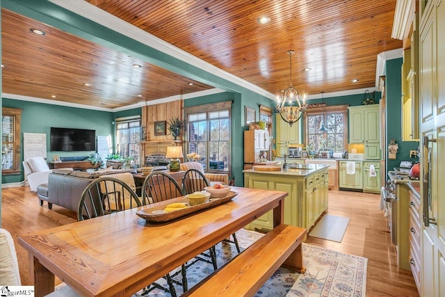 dining room with sink, crown molding, and a healthy amount of sunlight