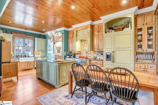 kitchen with light hardwood / wood-style floors, pendant lighting, a center island, ornamental molding, and a chandelier