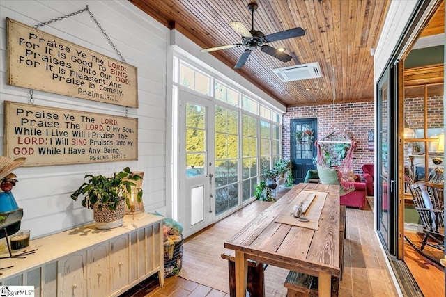 sunroom with ceiling fan and wood ceiling