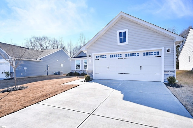 view of front of house with a garage and cooling unit