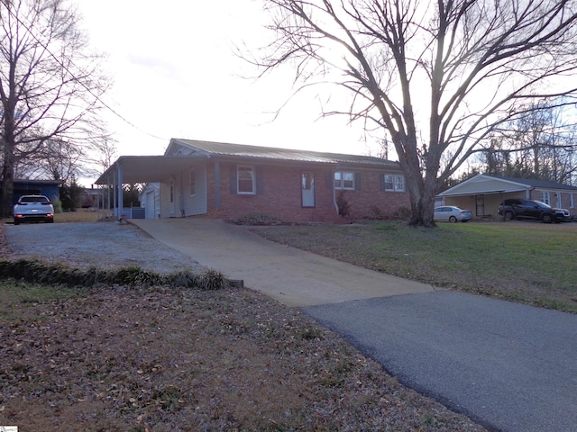 ranch-style house with a front yard and a carport