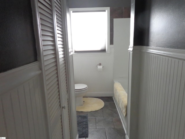 bathroom with toilet and tile patterned flooring