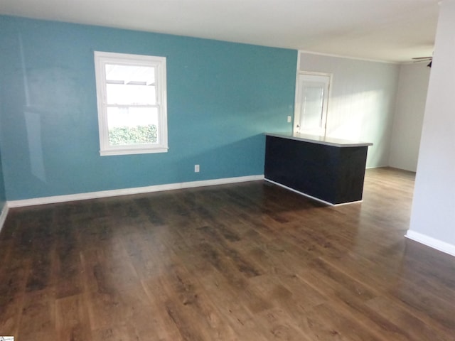 spare room featuring ceiling fan and dark hardwood / wood-style floors