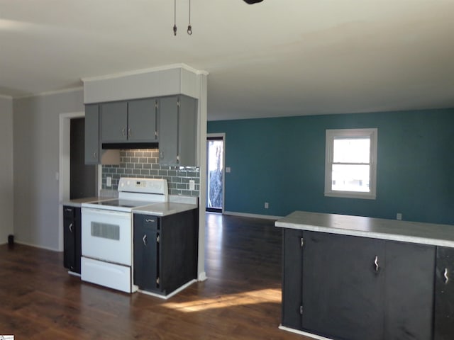 kitchen with backsplash, a healthy amount of sunlight, white electric stove, gray cabinetry, and dark hardwood / wood-style flooring