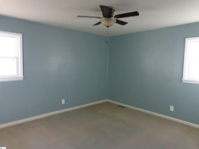 spare room featuring ceiling fan and carpet flooring