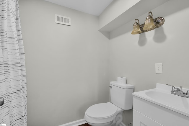 bathroom with toilet and vanity