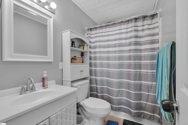 bathroom with toilet, vanity, crown molding, and a shower with curtain