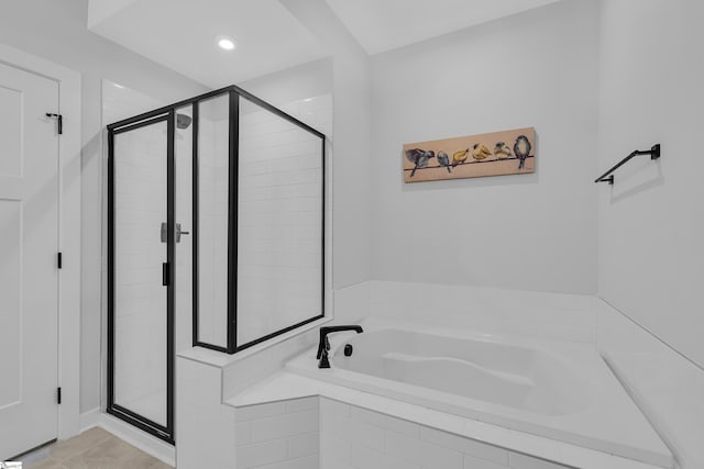 bathroom with independent shower and bath and tile patterned flooring