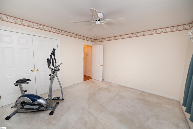 workout area featuring ceiling fan and light carpet