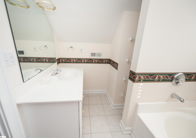 bathroom with vanity, a bath, tile patterned floors, and lofted ceiling