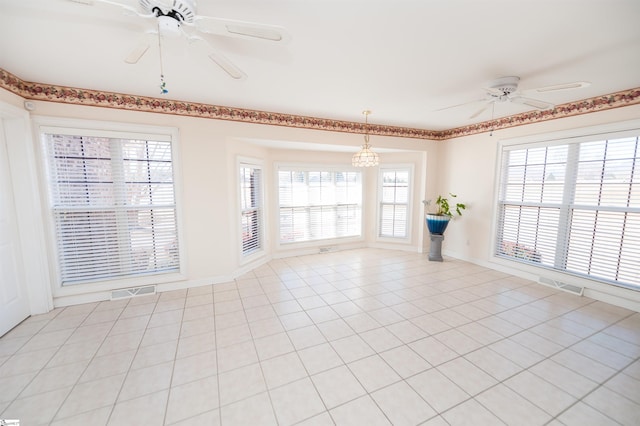 spare room with a wealth of natural light and light tile patterned floors