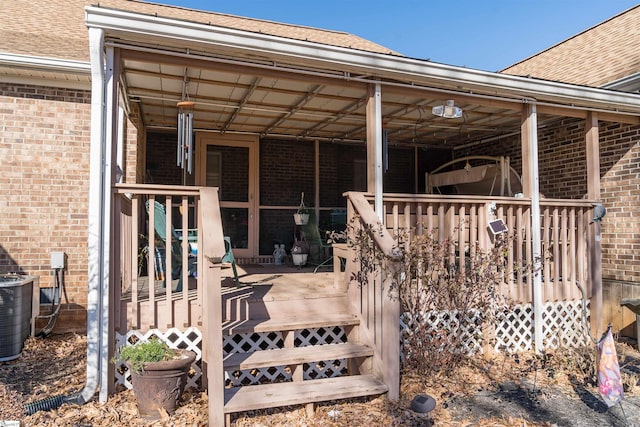 rear view of house featuring central AC