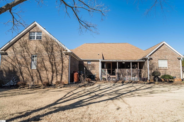 rear view of property featuring a porch