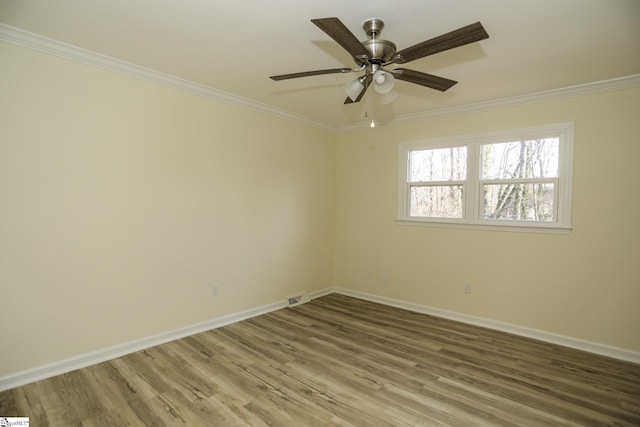 spare room with ceiling fan, wood-type flooring, and crown molding