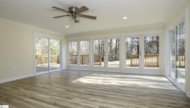 unfurnished sunroom with ceiling fan and french doors