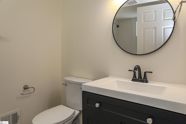 bathroom featuring toilet and vanity