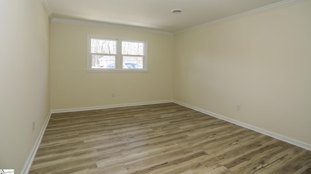 unfurnished room with ornamental molding and hardwood / wood-style flooring